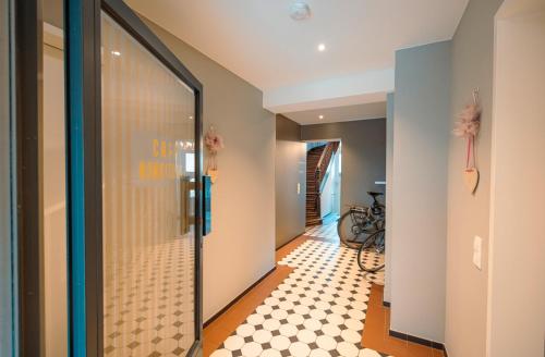 a hallway with a glass door with a checkered floor at Alte Konditorei in Lindau