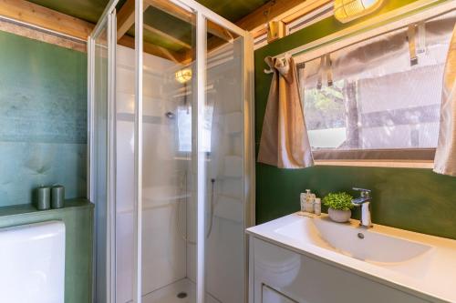 a bathroom with a sink and a shower at Club del Sole Orbetello Family Collection in Orbetello