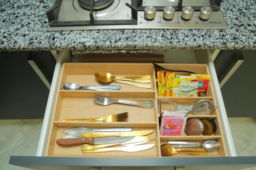 a drawer in a toy kitchen with utensils at Luxueux T3 à Oran. in Oran
