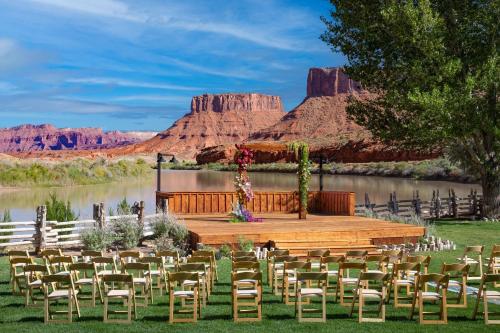 a set up for an outdoor ceremony with chairs and a stage at Red Cliffs Lodge Moab in Moab