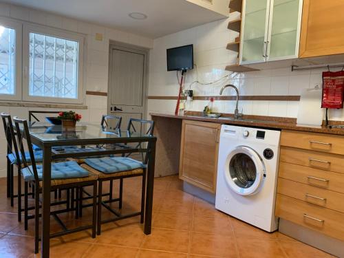 a kitchen with a table and a washing machine at Discovery Apartment Benfica in Lisbon