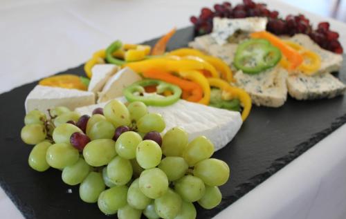 a plate of food with a bunch of grapes and cheese at Hotel Højbysø in Højby