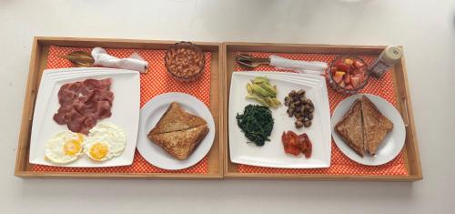 a wooden tray with plates of food on it at Joy's Place - Fourways BnB in Sandton