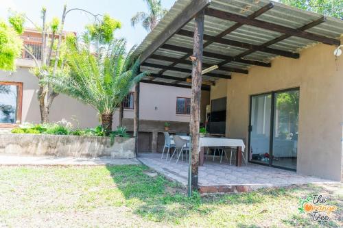 a pergola over a patio of a house at The Orange Tree Guest House in Nelspruit