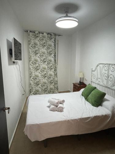 En eller flere senge i et værelse på Home Sweet beach 2 dormitorios