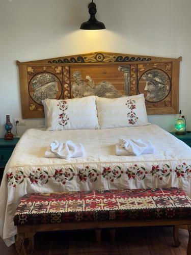 a bedroom with a bed with two swans on it at Saint Johns Hill Boutique Ephesus in Selcuk