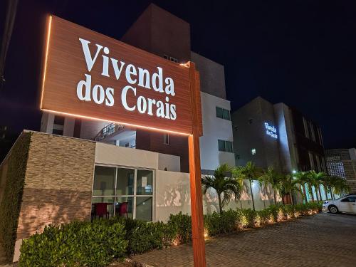 a sign that reads vivendi dos corrals in front of a building at Hotel Vivenda dos Corais in Porto De Galinhas