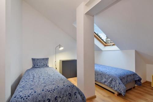 a bedroom with two beds in a attic at Być Morze in Pobierowo