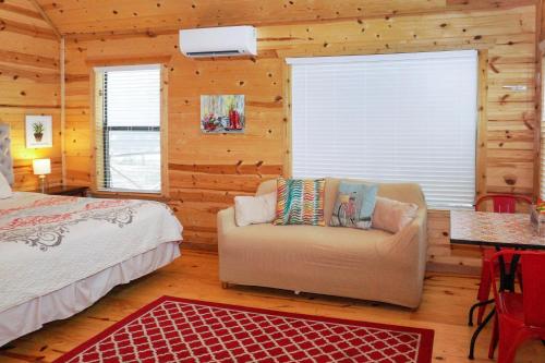 a bedroom with a bed and a couch in a room at Arbor House of Dripping Springs - Garden House in Dripping Springs