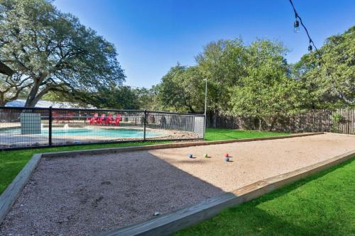 an empty sandbox in a yard next to a swimming pool at Wimberley Log Cabins Resort and Suites- Unit 7 in Wimberley