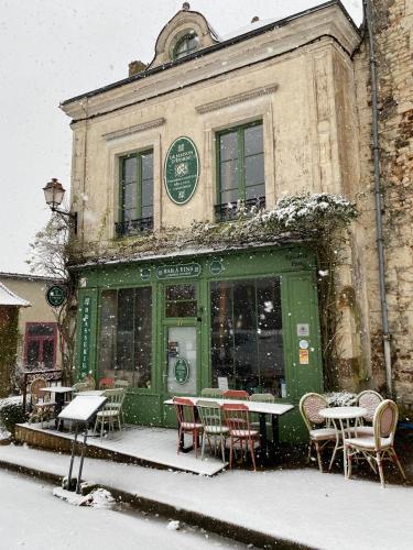 a restaurant with tables and chairs in the snow at La Maison d'Horbé in La Perrière