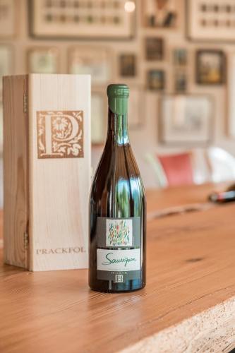 a bottle of wine sitting on top of a table at Prackfolerhof in Fie allo Sciliar