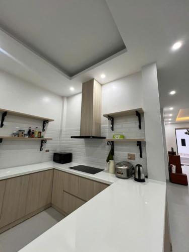 a kitchen with white walls and a white counter top at Liverpool House Mộc Châu in Mộc Châu