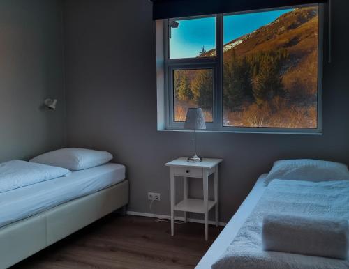 a bedroom with two beds and a window at Hótel Laugarvatn in Laugarvatn