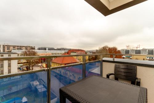 a balcony with a table and a view of a city at River Apartment Harmony by NW in Budapest
