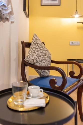 a table with a chair with a glass on it at Miglari in Stemnitsa
