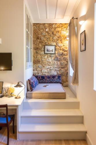 a bed on the stairs of a house at Miglari in Stemnitsa