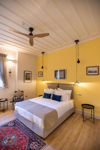 a bedroom with a bed with yellow walls and a ceiling at Miglari in Stemnitsa