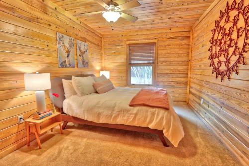 a bedroom with a bed in a log cabin at Fox Run Ridge in Wimberley
