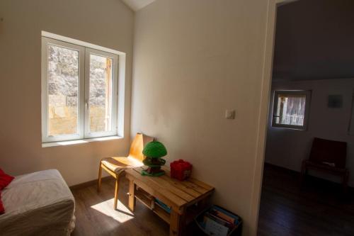 a room with a table with a green stuffed animal on it at La maison de famille in Mussidan