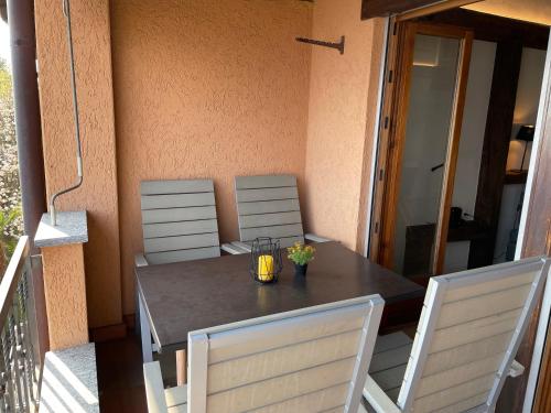 a table with two chairs and a candle on it at Belvedere by Fewotessin in Orselina