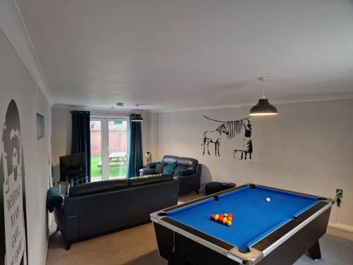 a living room with a pool table in it at Hereford - Finch House - Modern 4 Bedroom House Located in South Hereford, Dog Friendly With Nearby Countryside, Pool Table, Sleeps up to 10 Guests - Hosted by RENTMYHOUSE in Hereford
