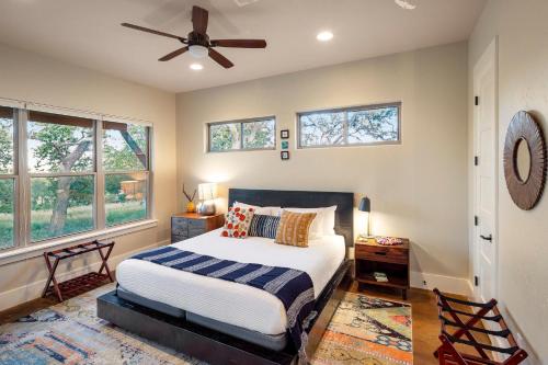 a bedroom with a bed and a ceiling fan at Driftwood Casitas - Moonlight Casita in Wimberley