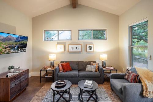 a living room with a couch and two tables at Driftwood Casitas - Moonlight Casita in Wimberley