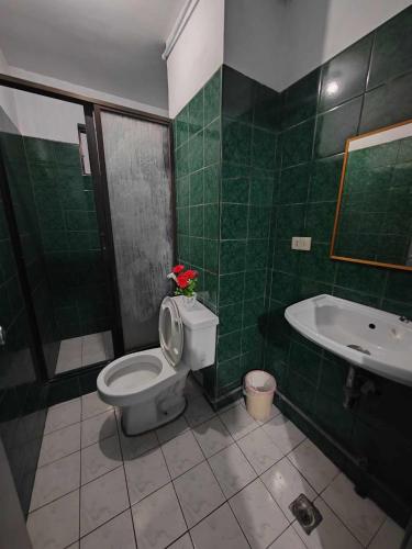 a bathroom with a toilet and a sink and a tub at Your Home at a Perfect Location in Baguio