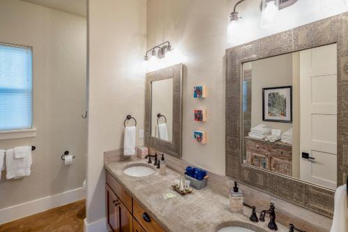 a bathroom with a sink and a large mirror at Driftwood Casitas - Moonlight Casita in Wimberley