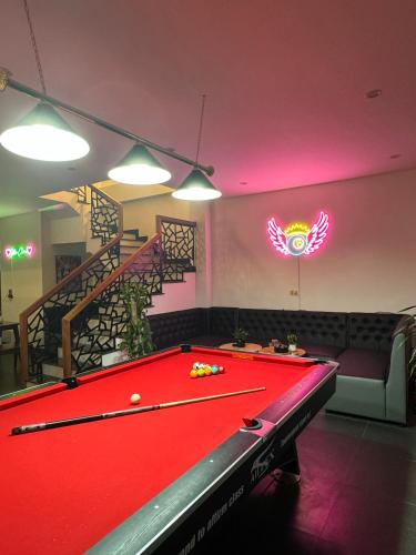 a red pool table in a room with a bill at Liverpool House Mộc Châu in Mộc Châu