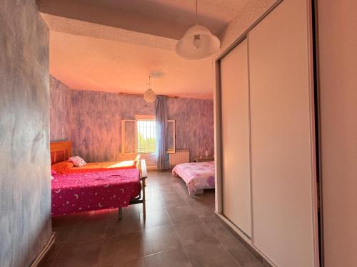 a bedroom with two beds and a window at La Canaleja in Candeleda
