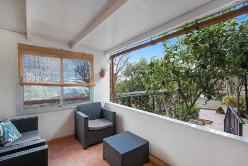a balcony with two chairs and a window at Villa Alejo in Valsequillo
