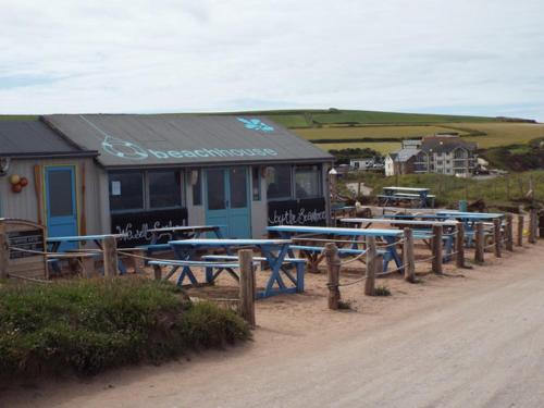 a row of picnic tables in front of a building at Bantham House, Bantham, South Devon - a few steps from golden sandy beaches in Bantham