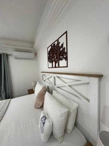 a bedroom with a white bed with white pillows at Omaha Luxury B&B & SPA in Mthatha