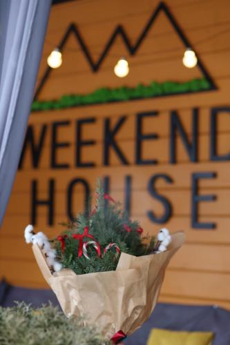 a basket of christmas trees in front of a welcome home sign at Weekend house in Verkhovyna