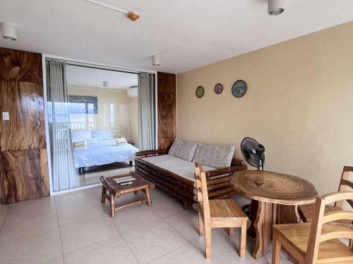a living room with a couch and a table at Boracay Amor Apartment in Boracay