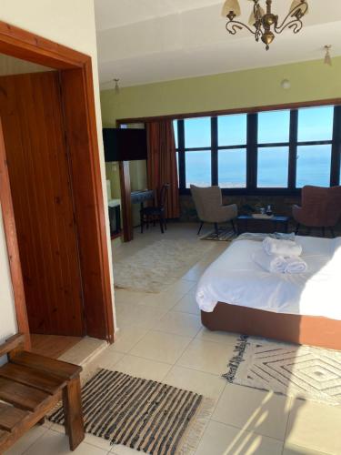 a bedroom with a bed and a living room at Pliades Traditional Guesthouse in Palaios Panteleimon