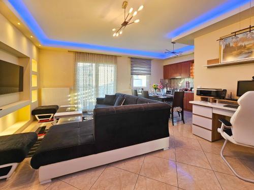 a living room with a couch and a kitchen at Dakis Luxury Apartments in Katerini