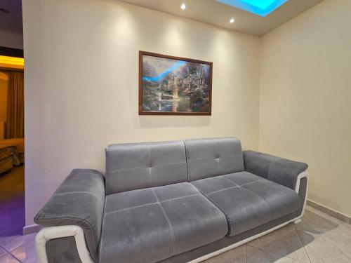 a couch in a room with a painting on the wall at Dakis Luxury Apartments in Katerini