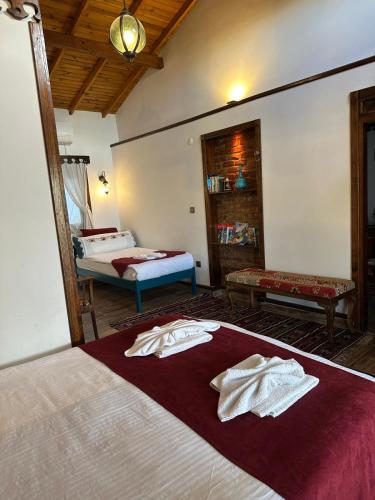 a bedroom with a bed with towels on it at Saint Johns Hill Boutique Ephesus in Selcuk