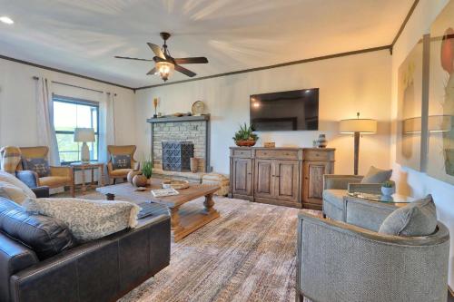 a living room with couches and a ceiling fan at Southwind at The Bend in Wimberley