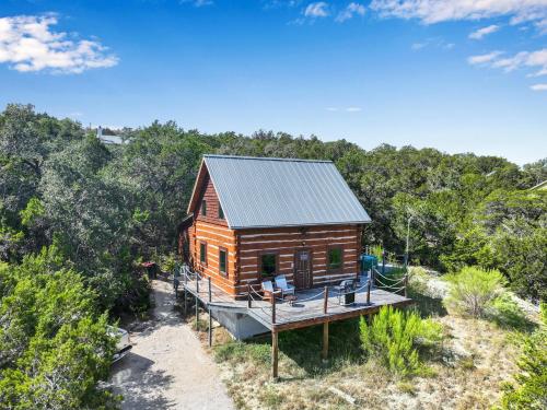 a cabin in the woods with a deck at Ozuye Lodge in Fischer