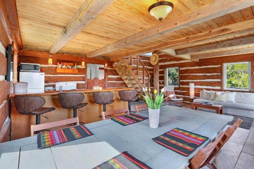 a dining room with a table and a kitchen at Ozuye Lodge in Fischer