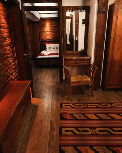 a room with a mirror and a chair and a bed at Saint Johns Hill Boutique Ephesus in Selcuk
