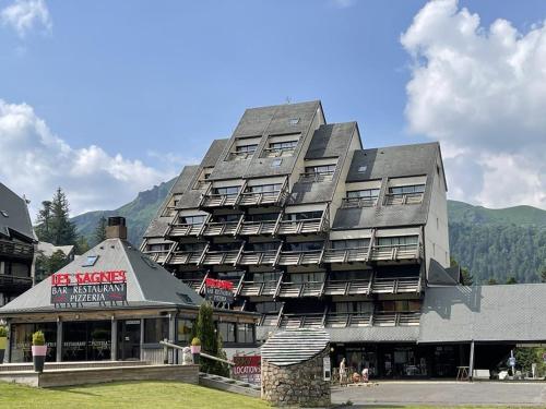 - un grand bâtiment avec un restaurant en face dans l'établissement Duplex cosy 6-8 pers. pieds des pistes avec balcon - FR-1-787-88, à Laveissière