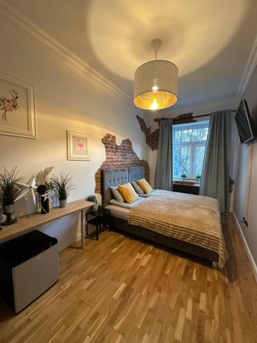 a bedroom with a bed and a large window at Apartamenty Narutowicza 52 parking free in Lublin