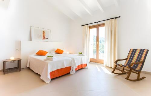 a white bedroom with a bed and a chair at Pula Bonavista Ref 140 in Costa des Pins