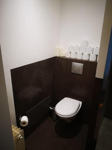 a small bathroom with a toilet and rolls of toilet paper at Trés bel appartement au pied des pistes in Métabief