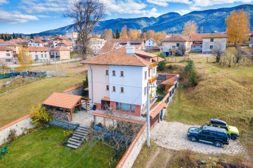an aerial view of a house with a truck parked next to it at Cozy Luxurious Apartment Next to Borovets and Rila mountain in Govedartsi